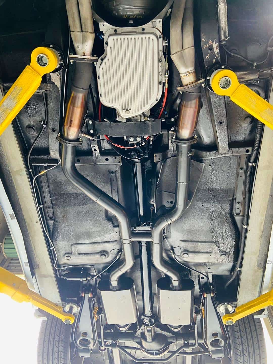 A Close Up of the Underside of a Car on a Lift — South Coast Radiators In Liverpool, NSW