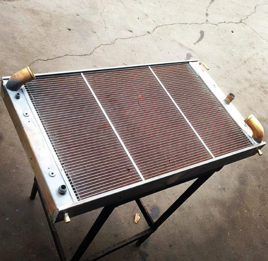 A Metal Radiator With Wooden Handles Sits on a Table — South Coast Radiators In Brisbane, QLD