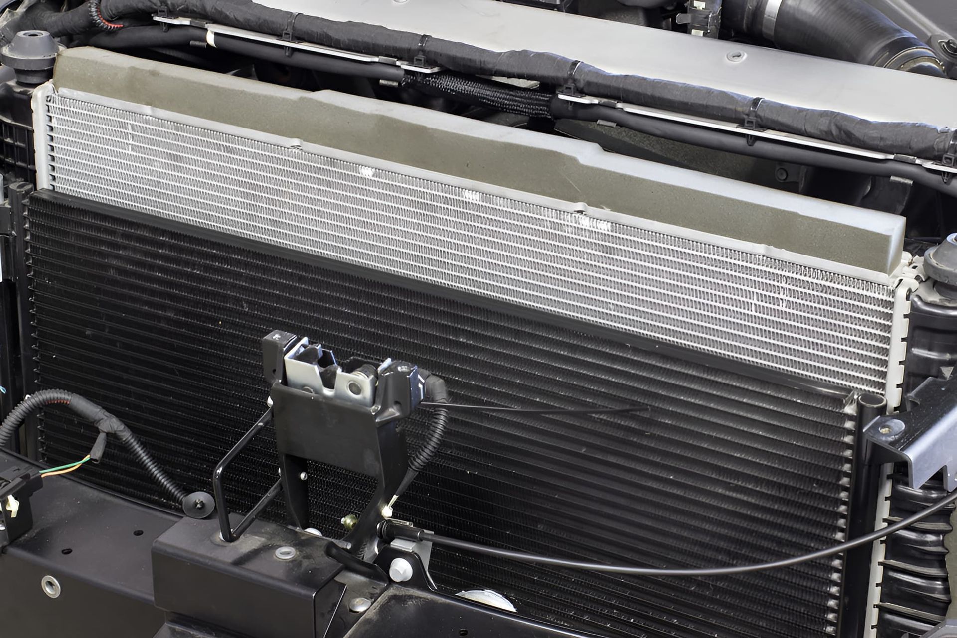 A Close Up of the Underside of a Car on a Lift — South Coast Radiators In Woonona, NSW