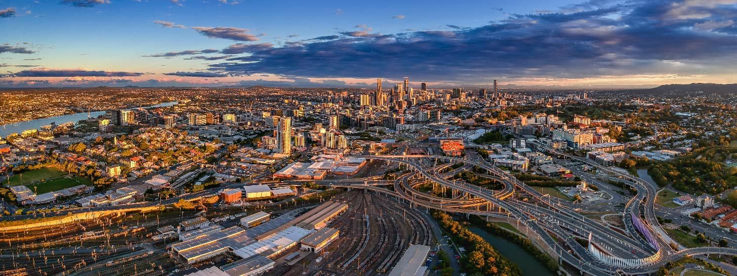 An Aerial View of a City at Night With a River Running Through It — South Coast Radiators In Brisbane, QLD