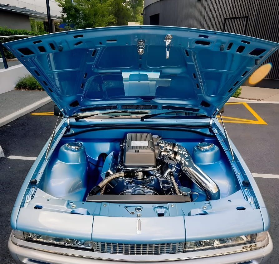 A Blue Car With the Hood Open Shows the Engine — South Coast Radiators In Woonona, NSW