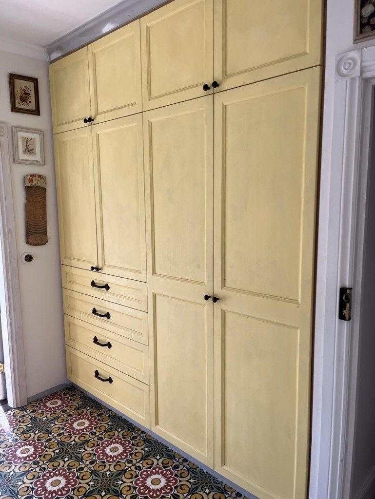 A Closet With Yellow Cabinets and Drawers in a Hallway — D Hinged Kitchens & Joinery in Byron Bay, NSW