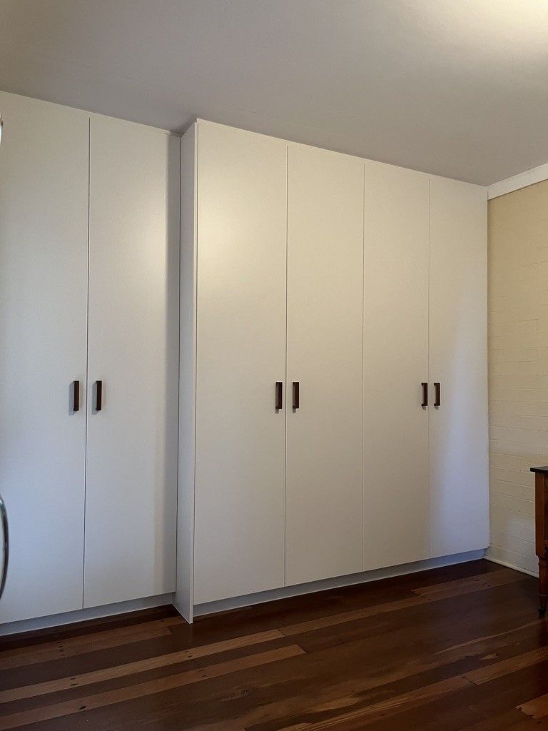 A Bedroom With White Cabinets and a Wooden Floor — D Hinged Kitchens & Joinery in Bangalow, NSW