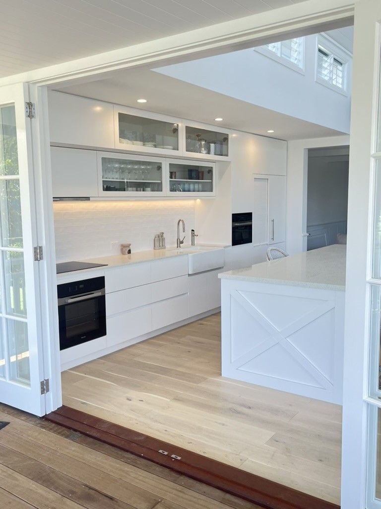 Kitchen With White Cabinets, Stainless Steel Appliances, and Wooden Floors — D Hinged Kitchens & Joinery in Main Arm, NSW