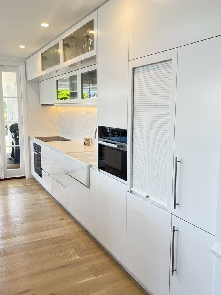 A Kitchen With White Cabinets and Wooden Floors — D Hinged Kitchens & Joinery in Brunswick Heads, NSW