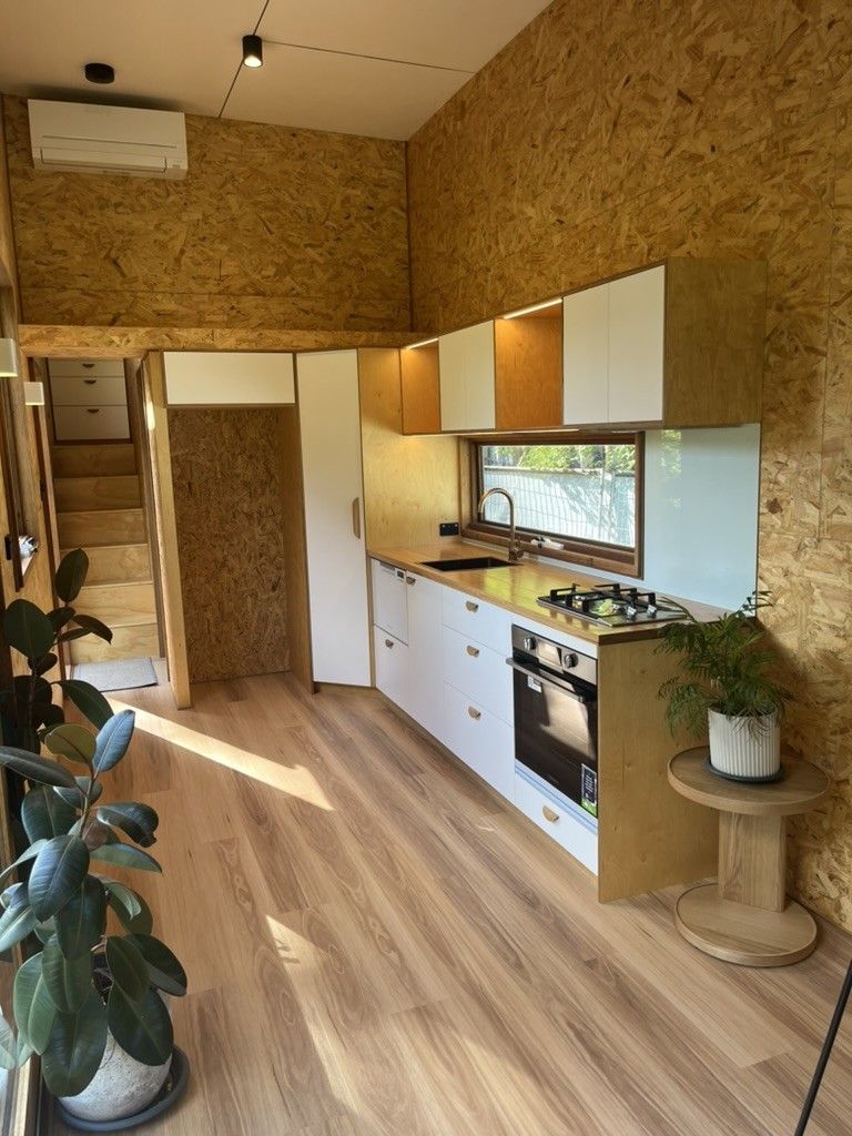 A Kitchen With Wooden Cabinets, a Stove, and a Window — D Hinged Kitchens & Joinery in Byron Bay, NSW