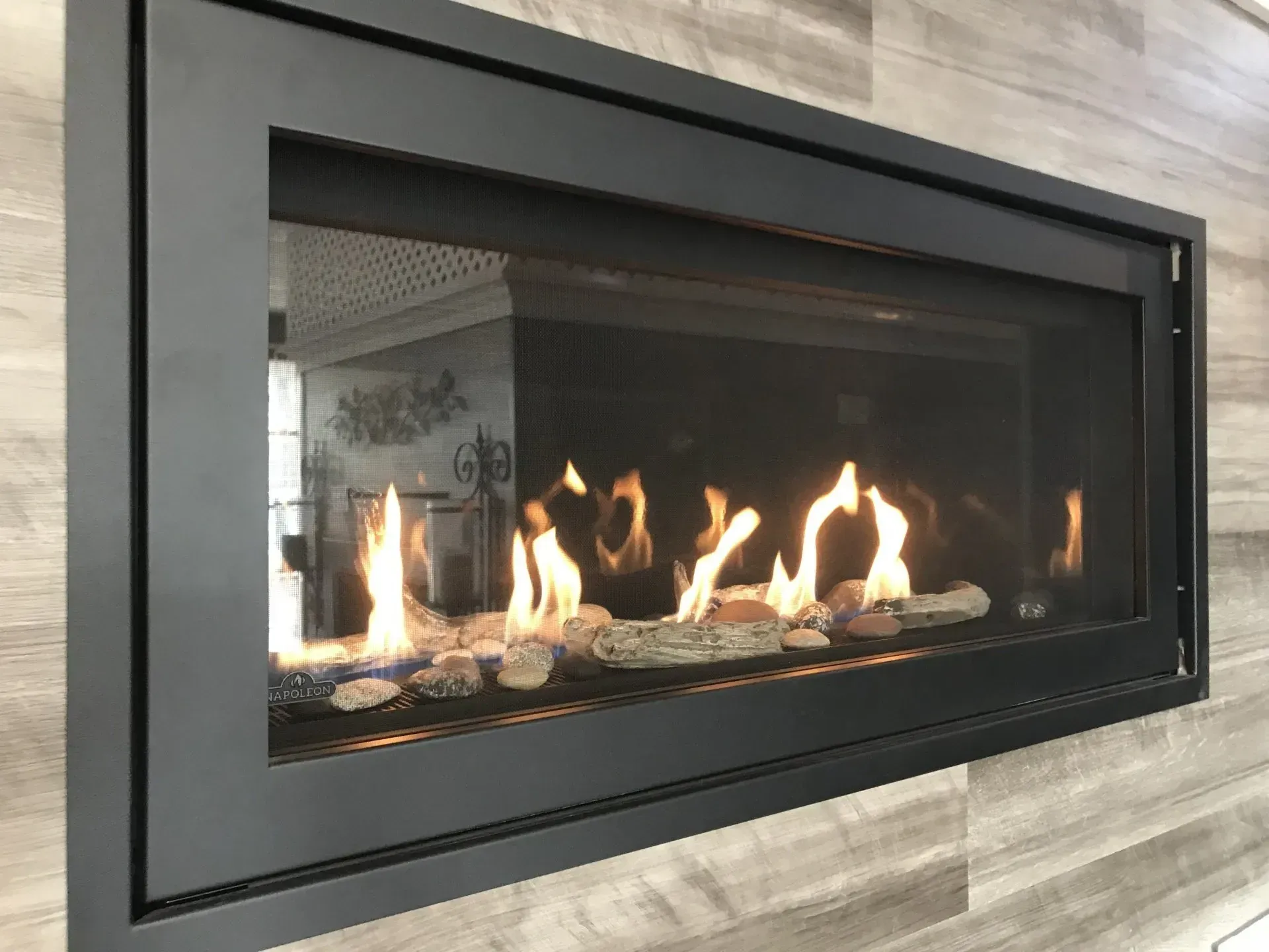 a fireplace with flames coming out of it is hanging on a wall