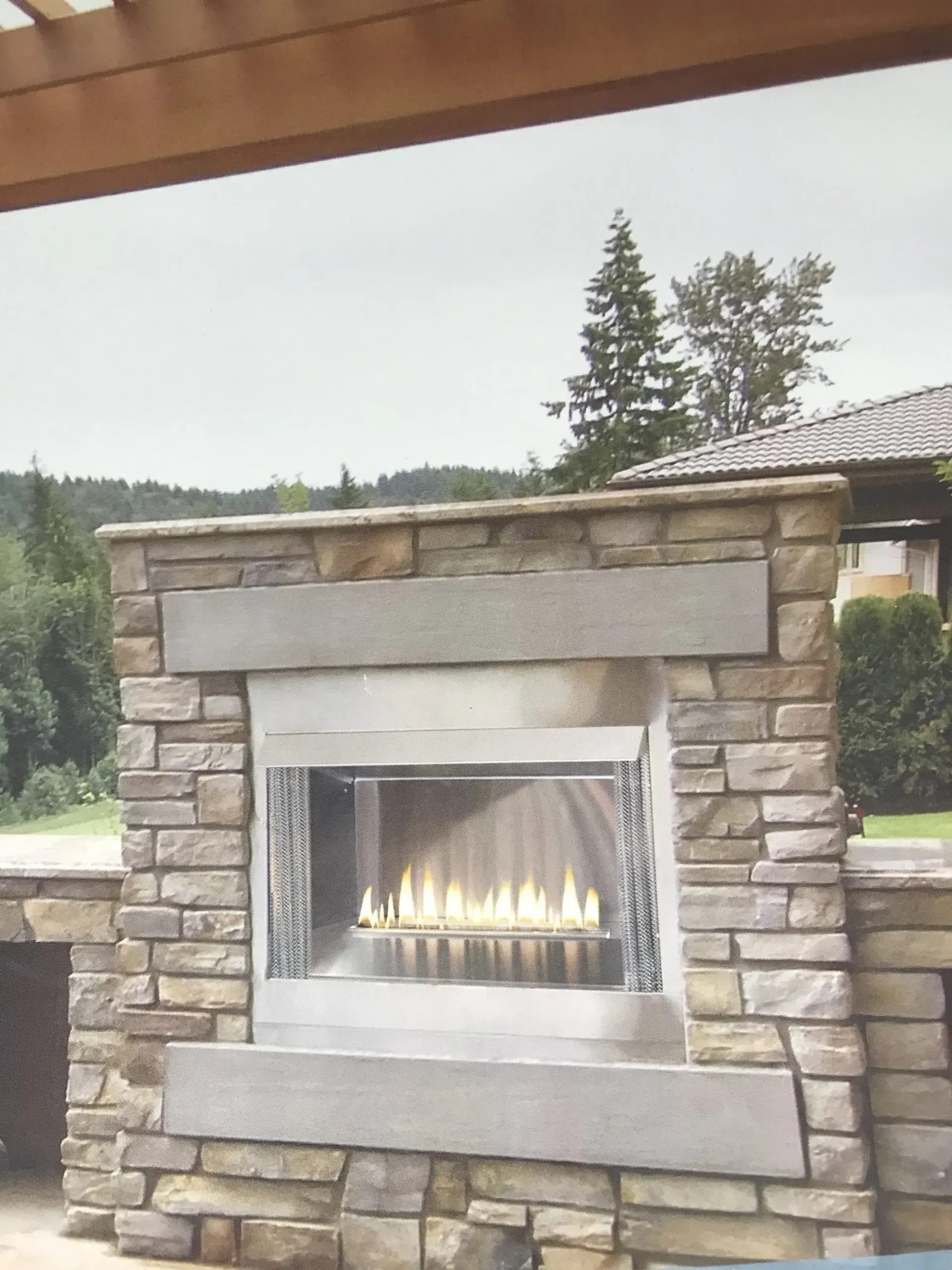 a stone fireplace with a stainless steel burner
