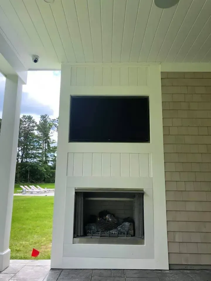 there is a fireplace with a television mounted on it