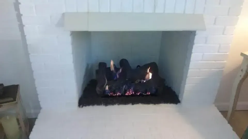 a fireplace with a lot of fire in it in a living room