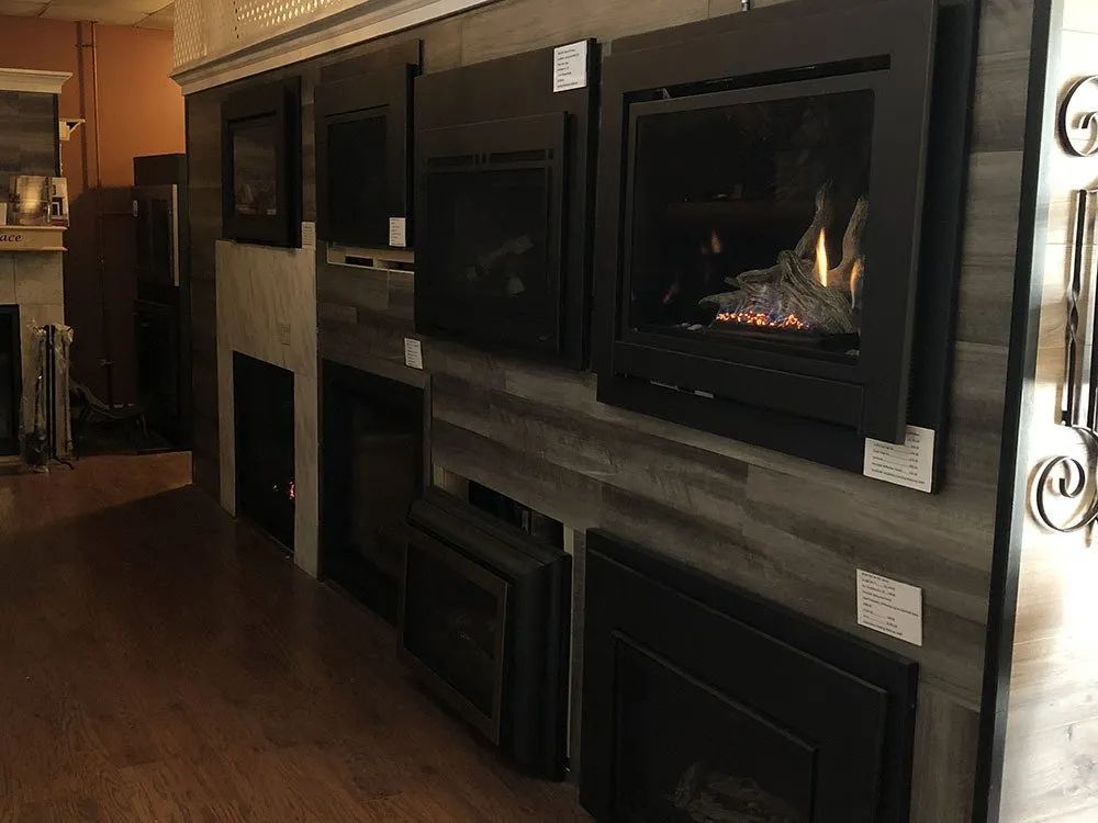A room with a lot of fireplace inserts on the wall.