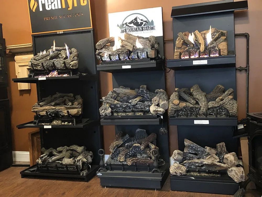 There are many different types of fireplaces on display in this store.