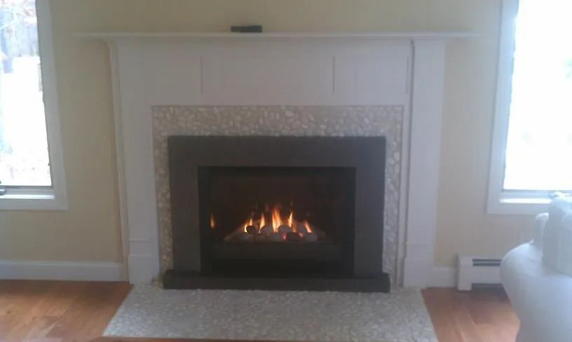 A living room with a fireplace and a window.