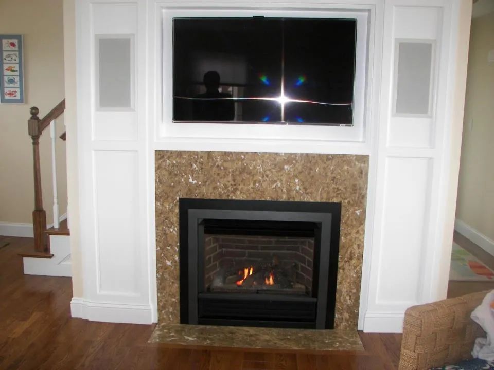 A fireplace with a flat screen tv above it