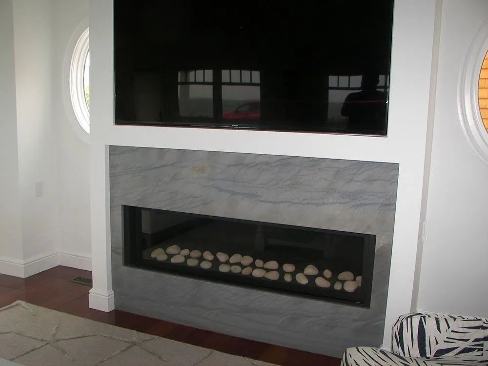 A fireplace with a flat screen tv above it