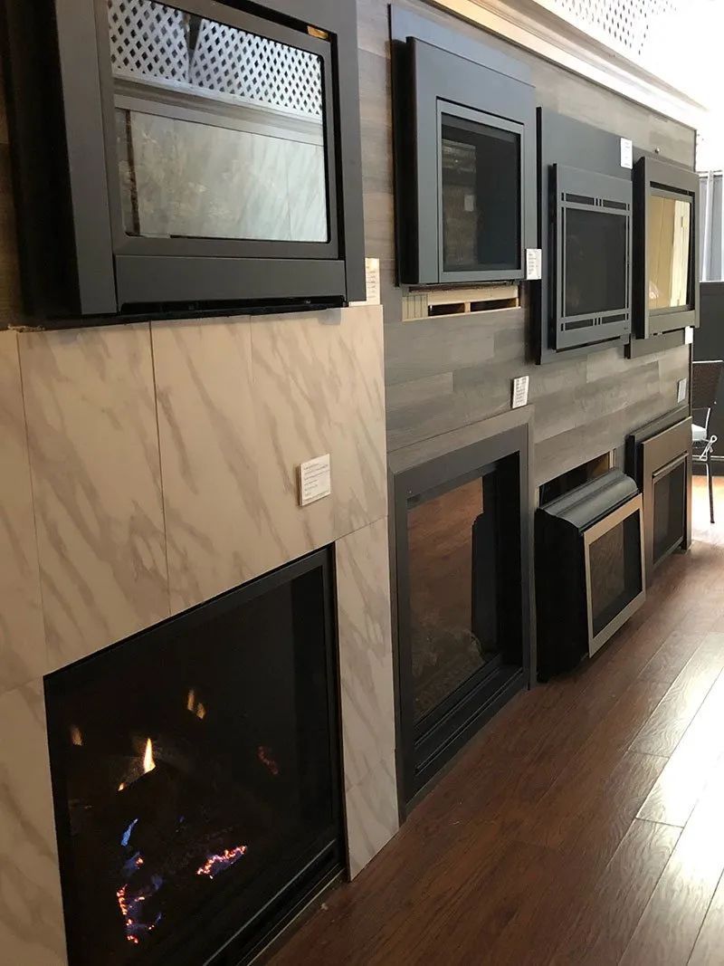 A room with a lot of fireplace and televisions on the wall