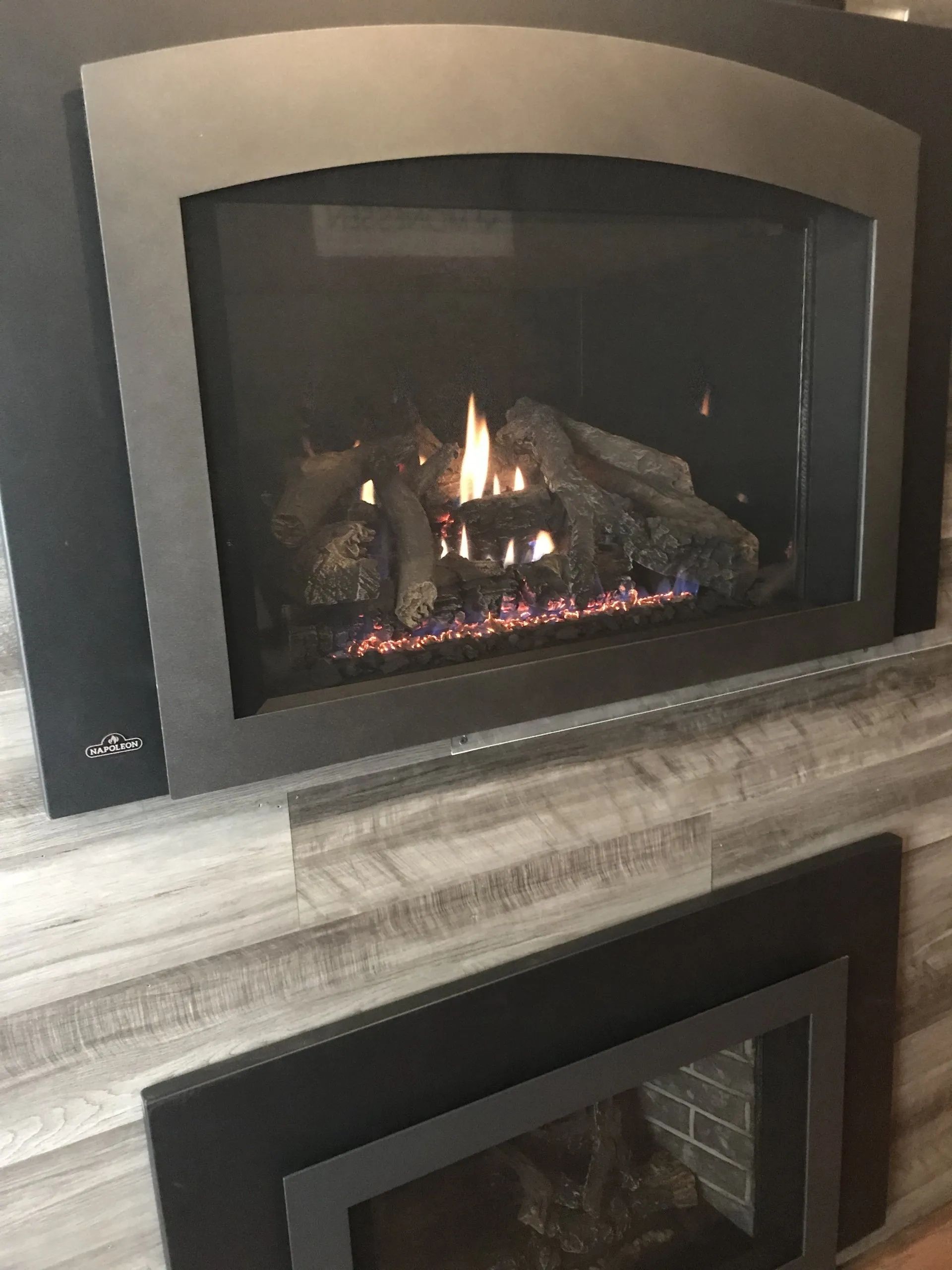 Two gas fireplaces are sitting next to each other in a living room.