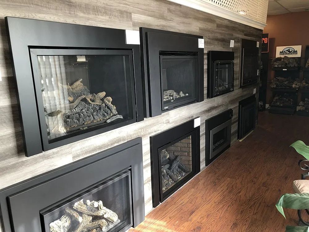 A showroom filled with a variety of fireplace inserts.