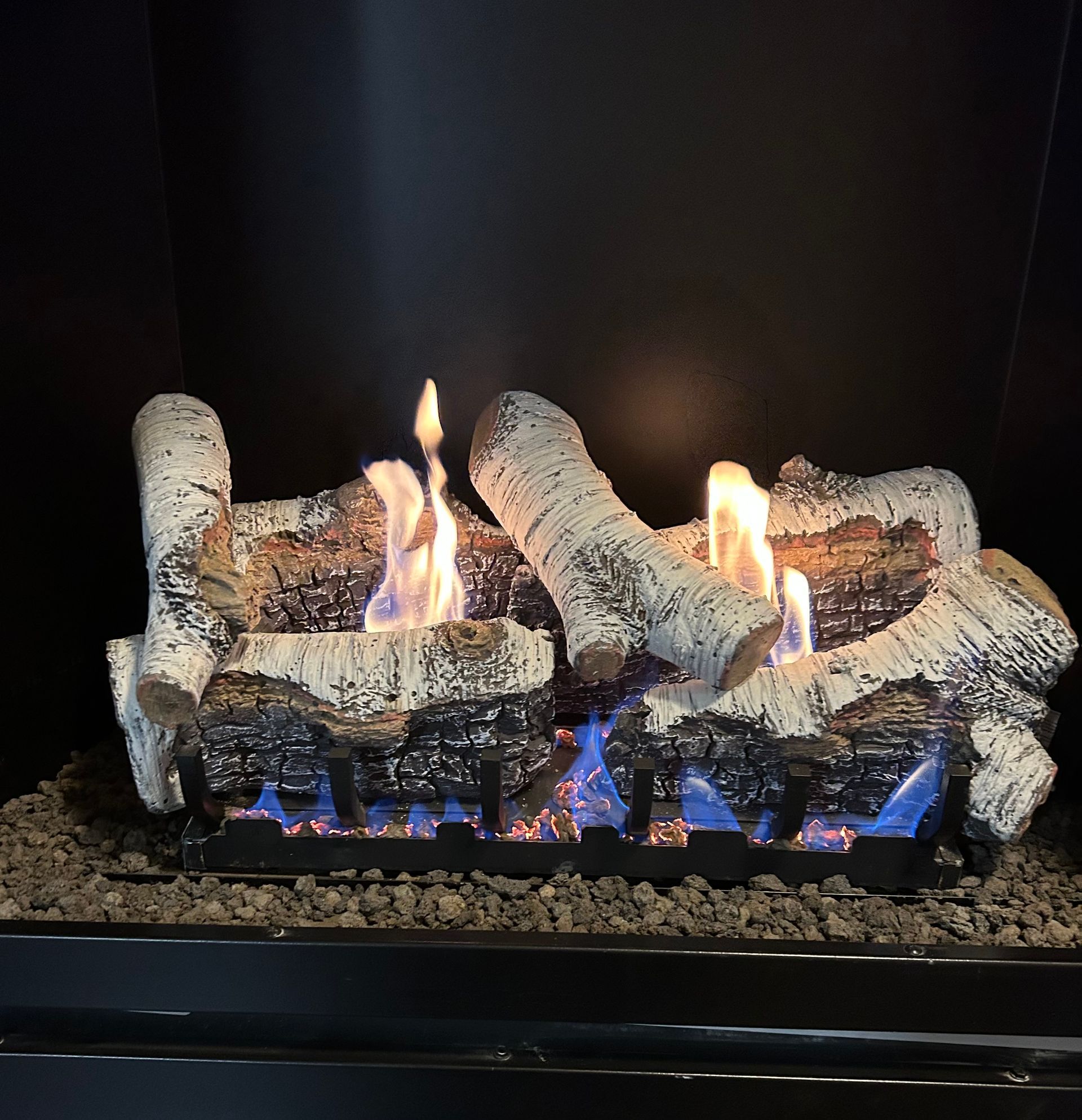 A fireplace with a bunch of logs on it