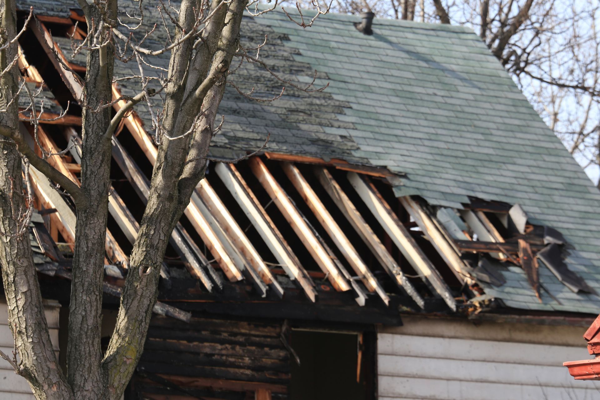 A man is working on the roof of a house