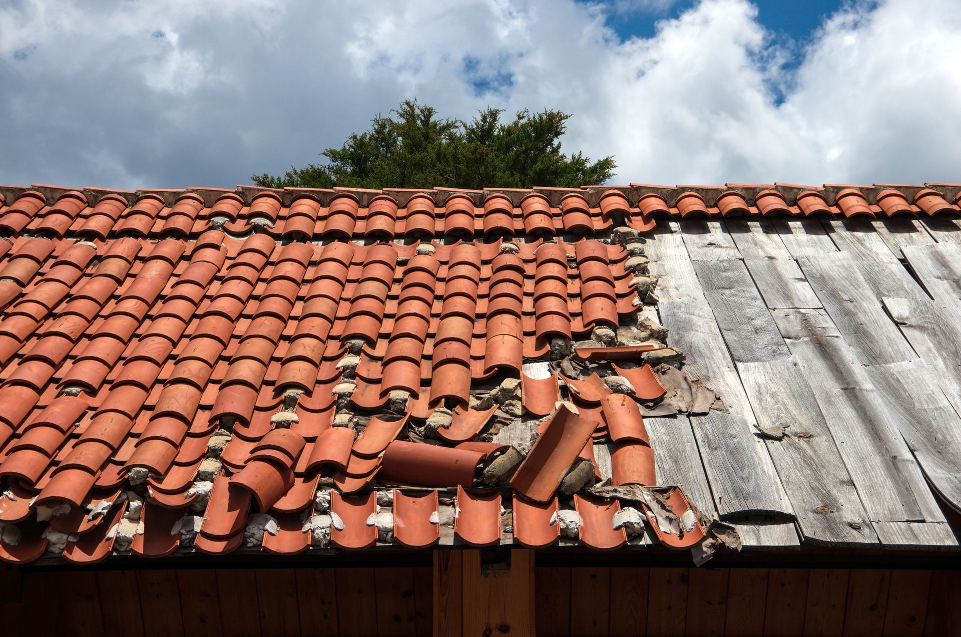 A man is working on the roof of a house