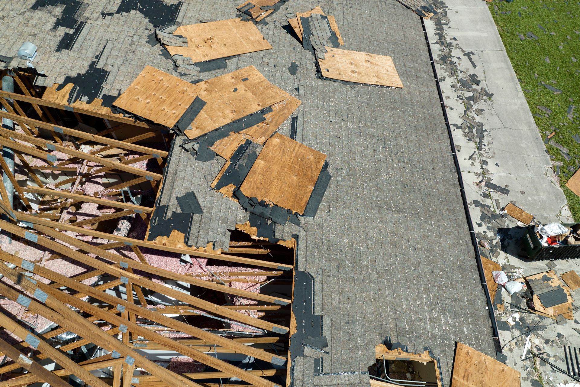 An aerial view of a roof that has been damaged by a storm