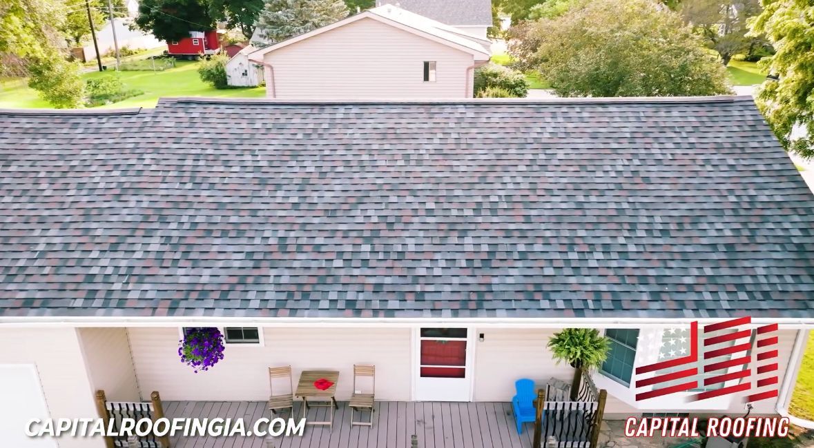 A house with a brown roof and a chimney on the roof.