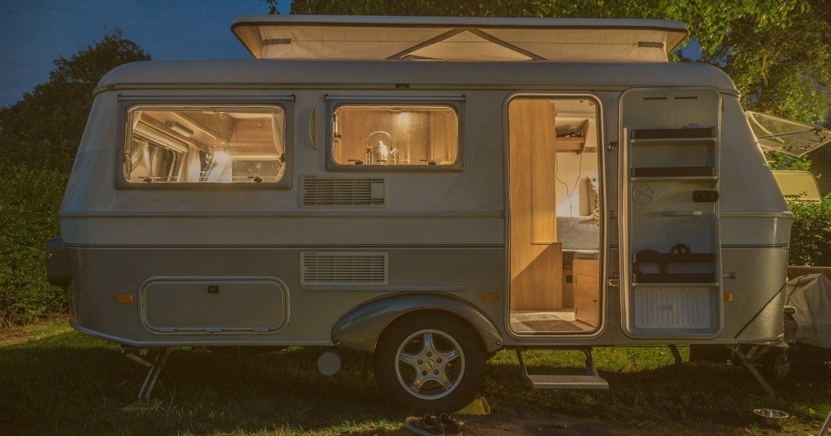 a camper trailer with lights on