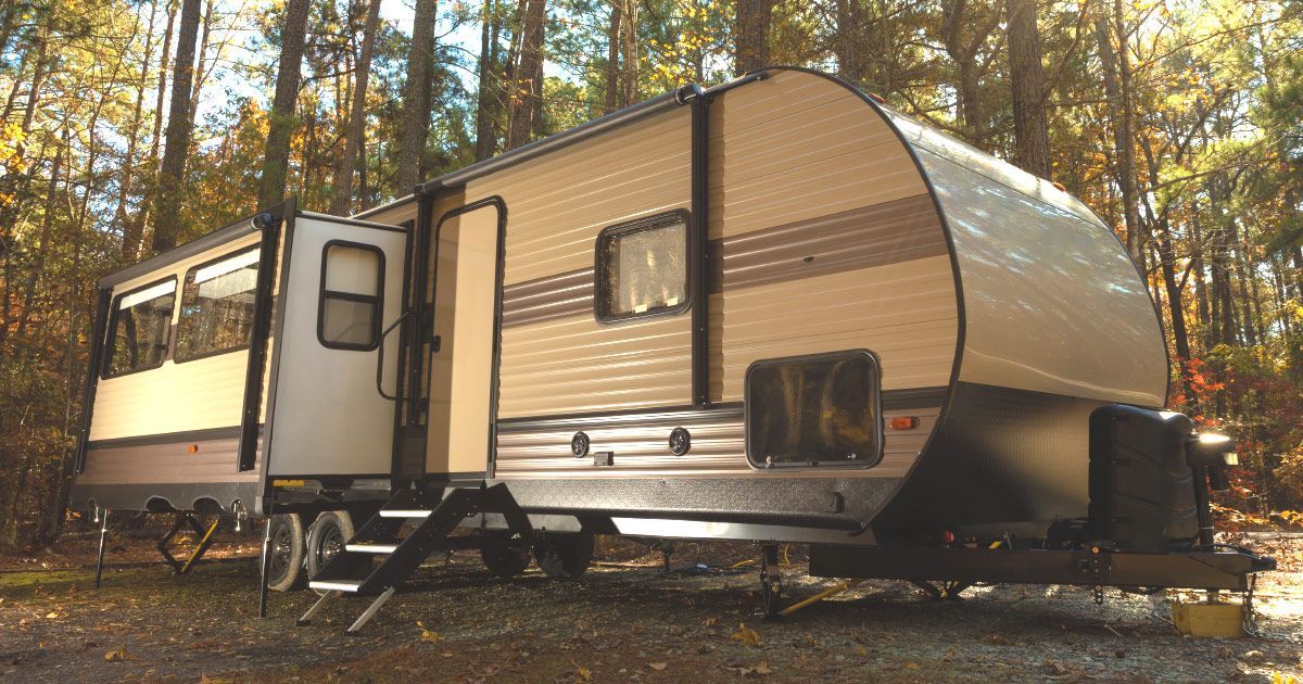 A trailer is parked in the middle of a forest