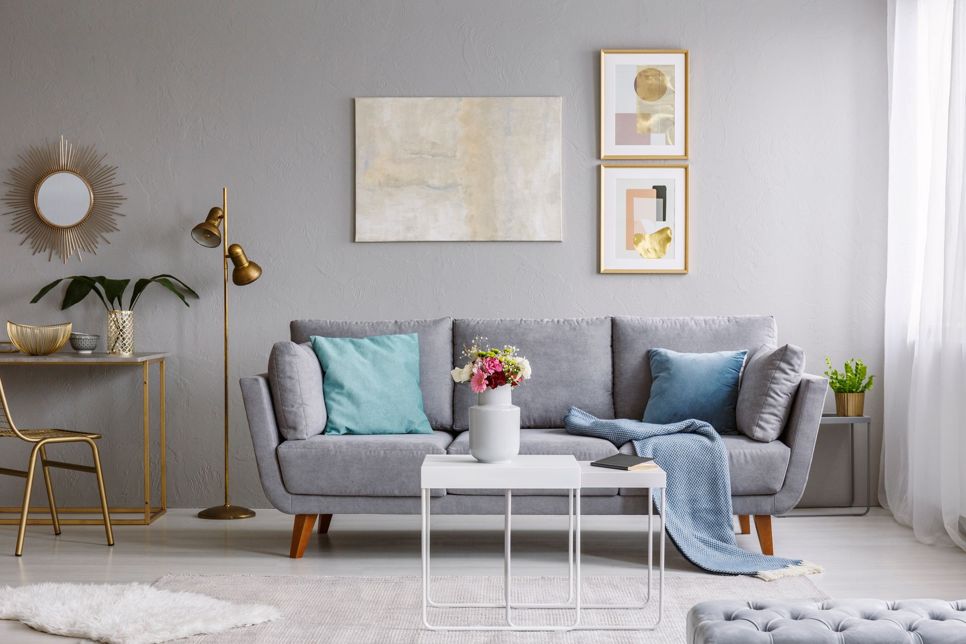 A living room with a gray couch and a white coffee table.