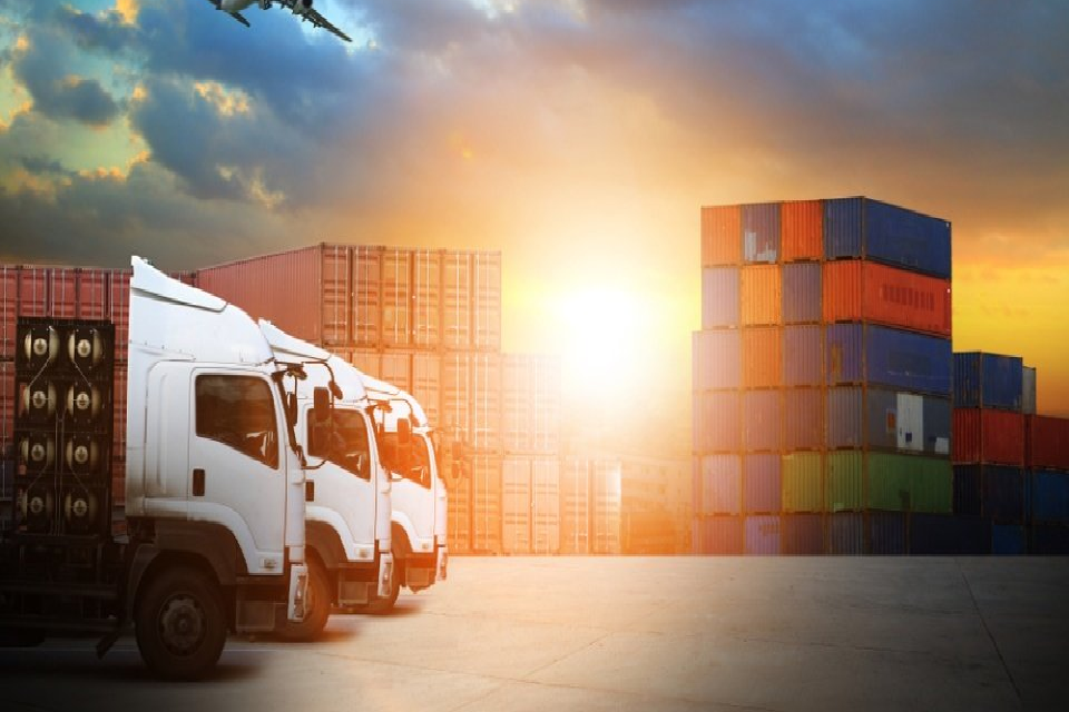 transport vehicle parked on the dock with stack of containers