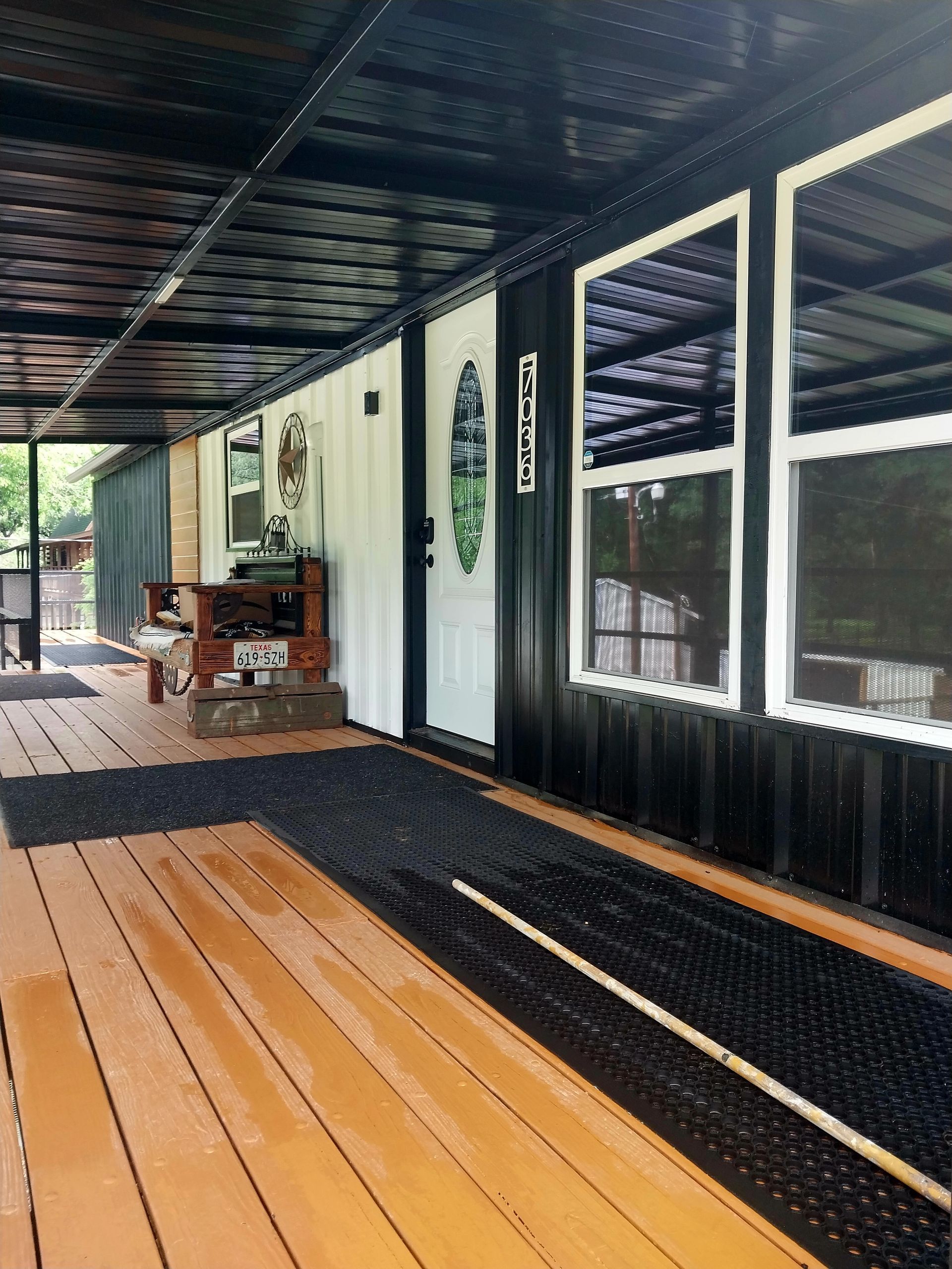 A black and white house with a wooden porch