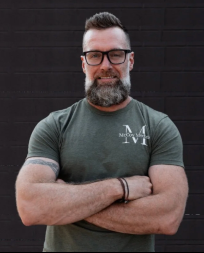 Logo for CrossFit Medical Society Community Care; blue and gray crescent shapes forming a