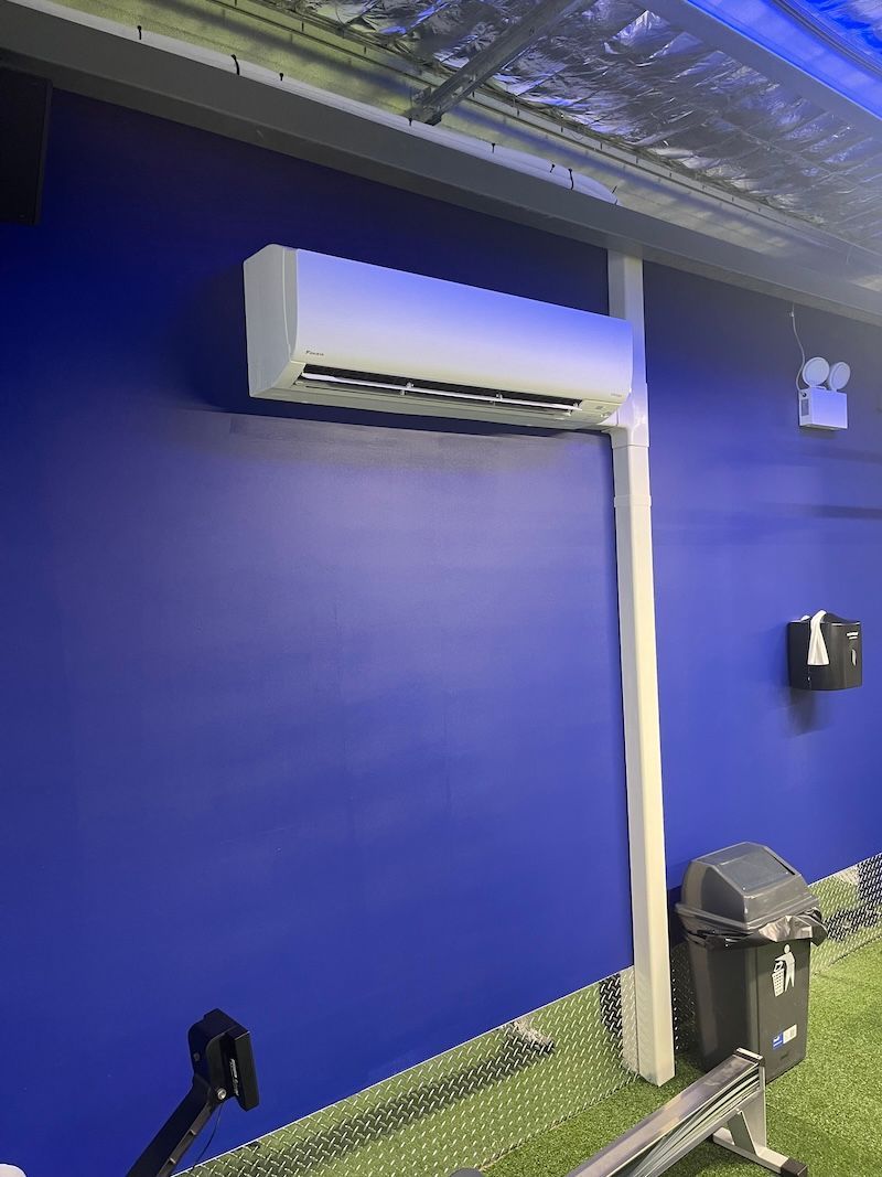 Person Turning On Air Con — Air Conditioning Hunter Valley, New South Wales