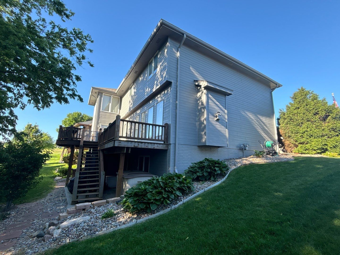 The back of a house with a deck and stairs.