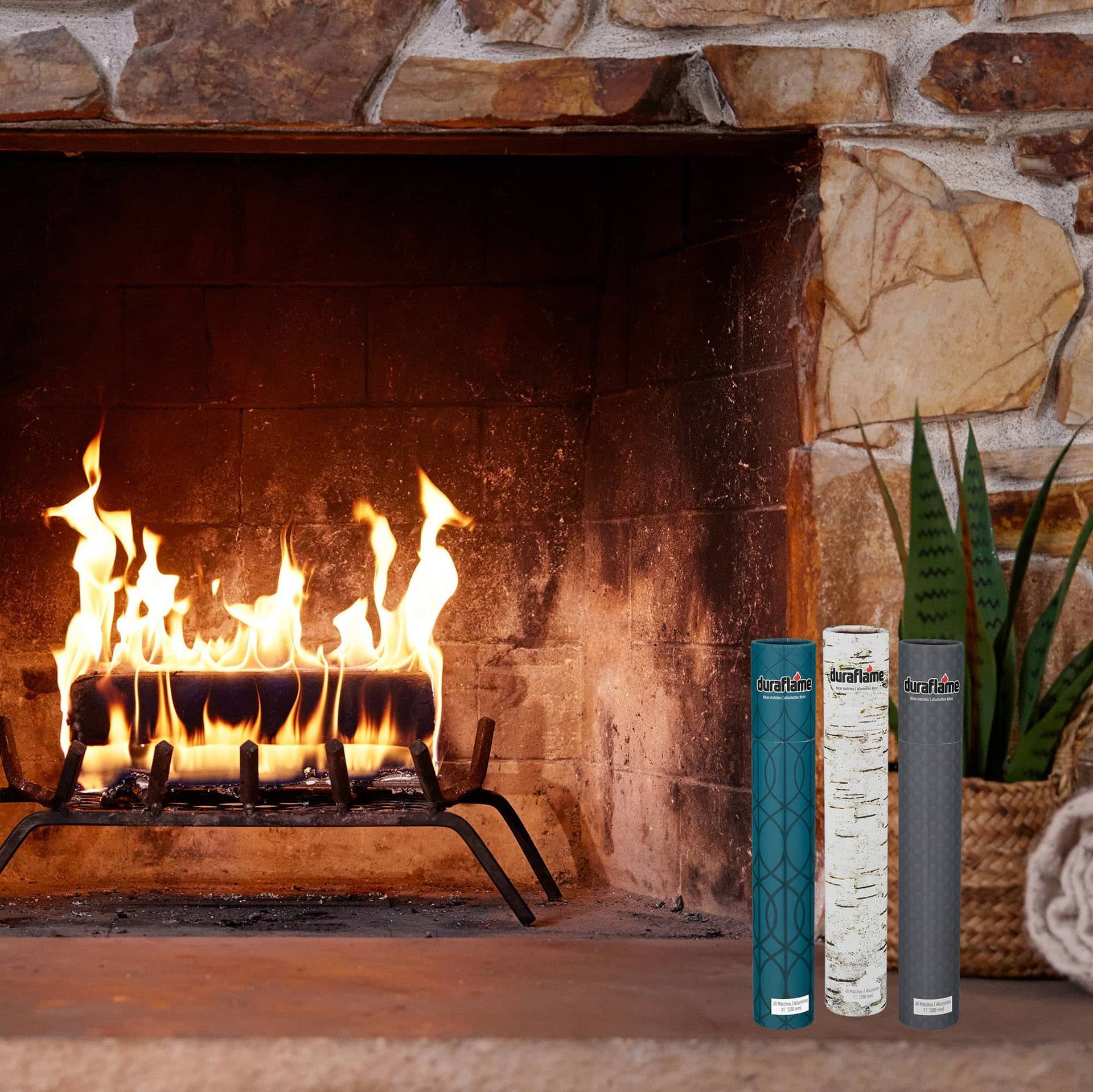 A duraflame fire burning in the fireplace with 3 tubes of duraflame decor long-stem matches