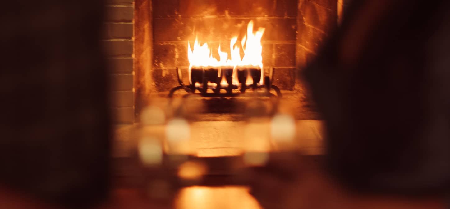 A close up of a duraflame firelog burning in a fireplace 