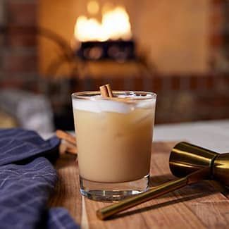 spiced chai cocktail with a duraflame fire in the background