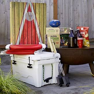 A white cooler is sitting on top of a wooden table.