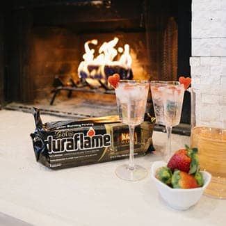 Cup of hot chocolate with marshmallows and cinnamon on a plate.