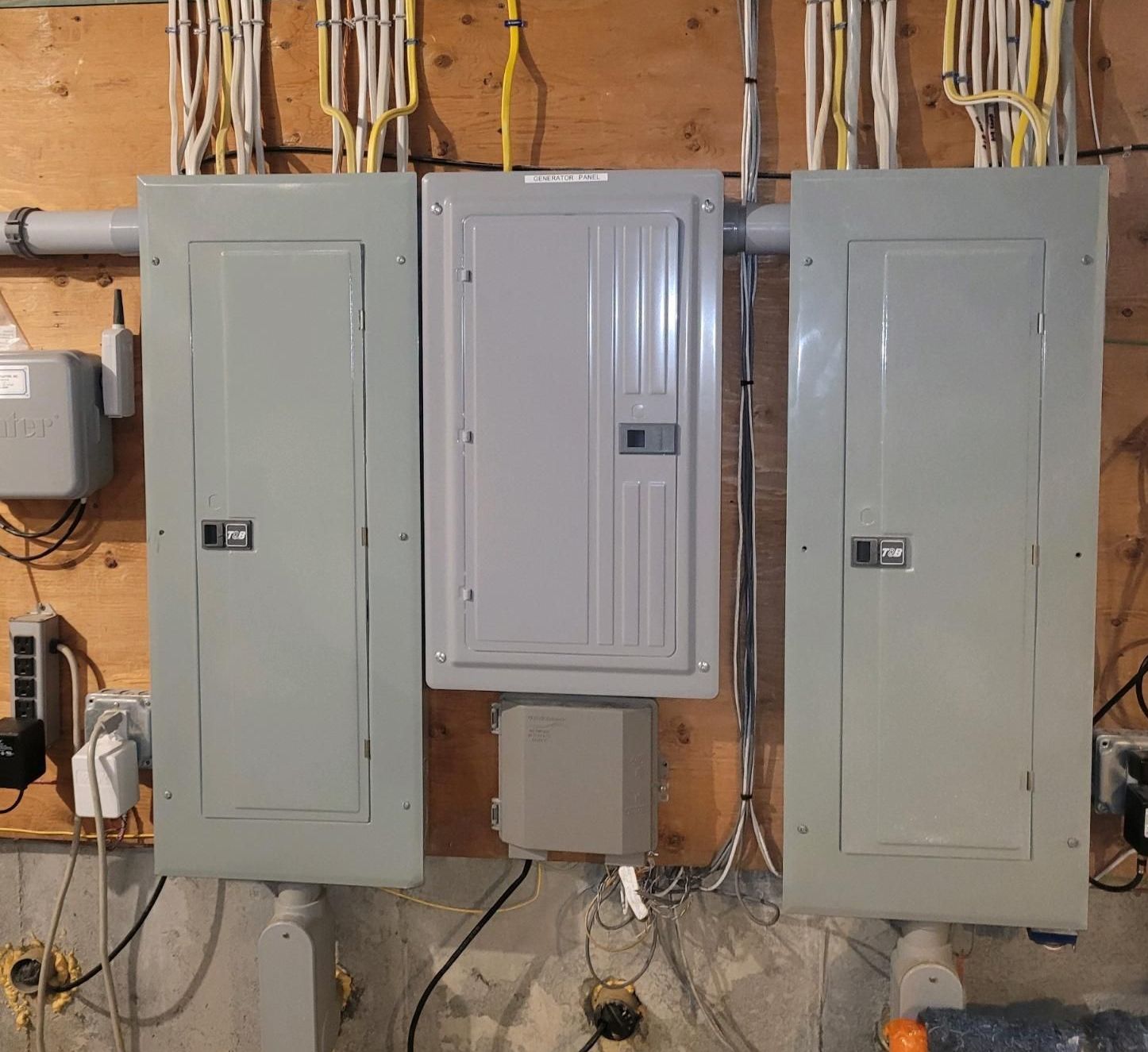 A bunch of electrical panels are hanging on a wall