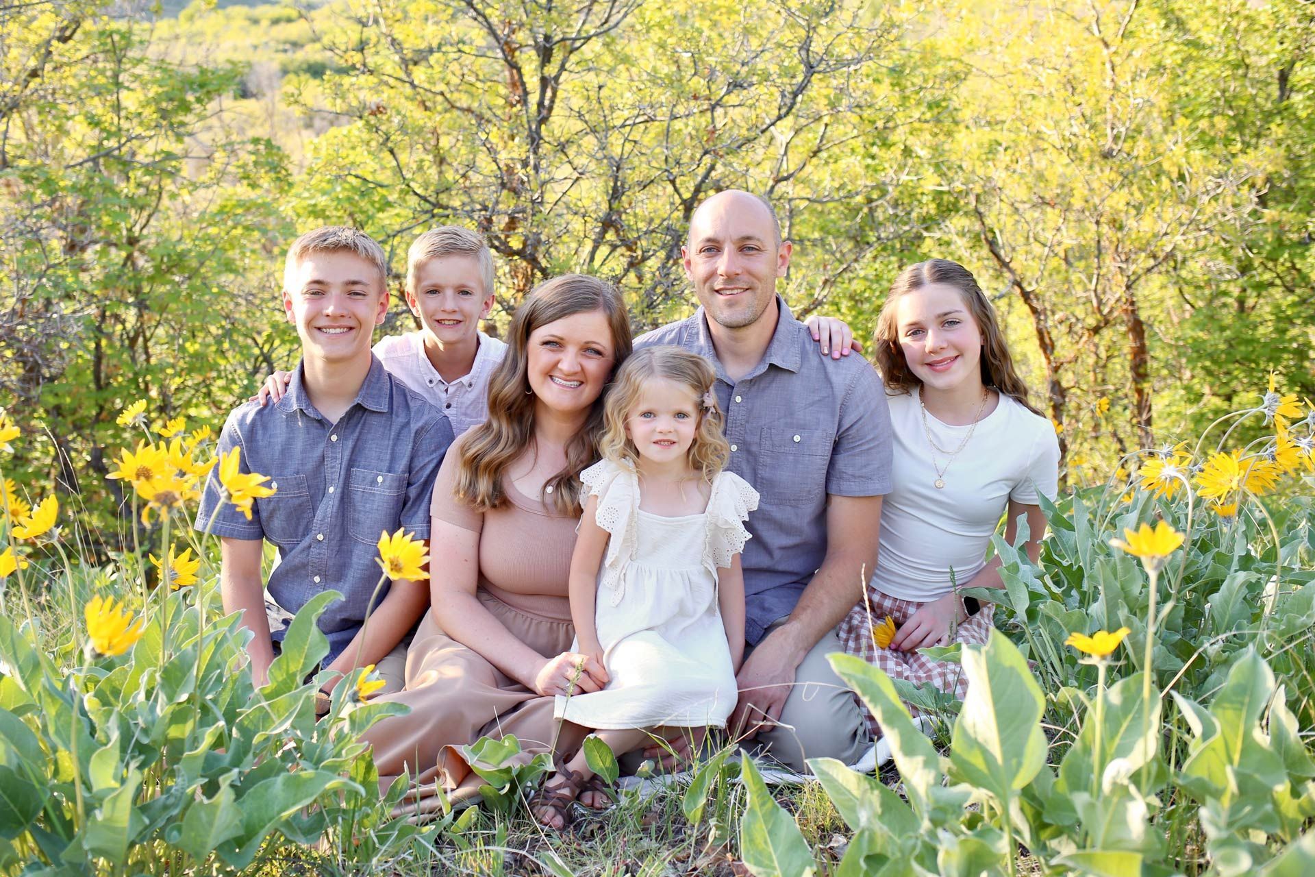Family portrait: Woman, man, and four children posing together.
