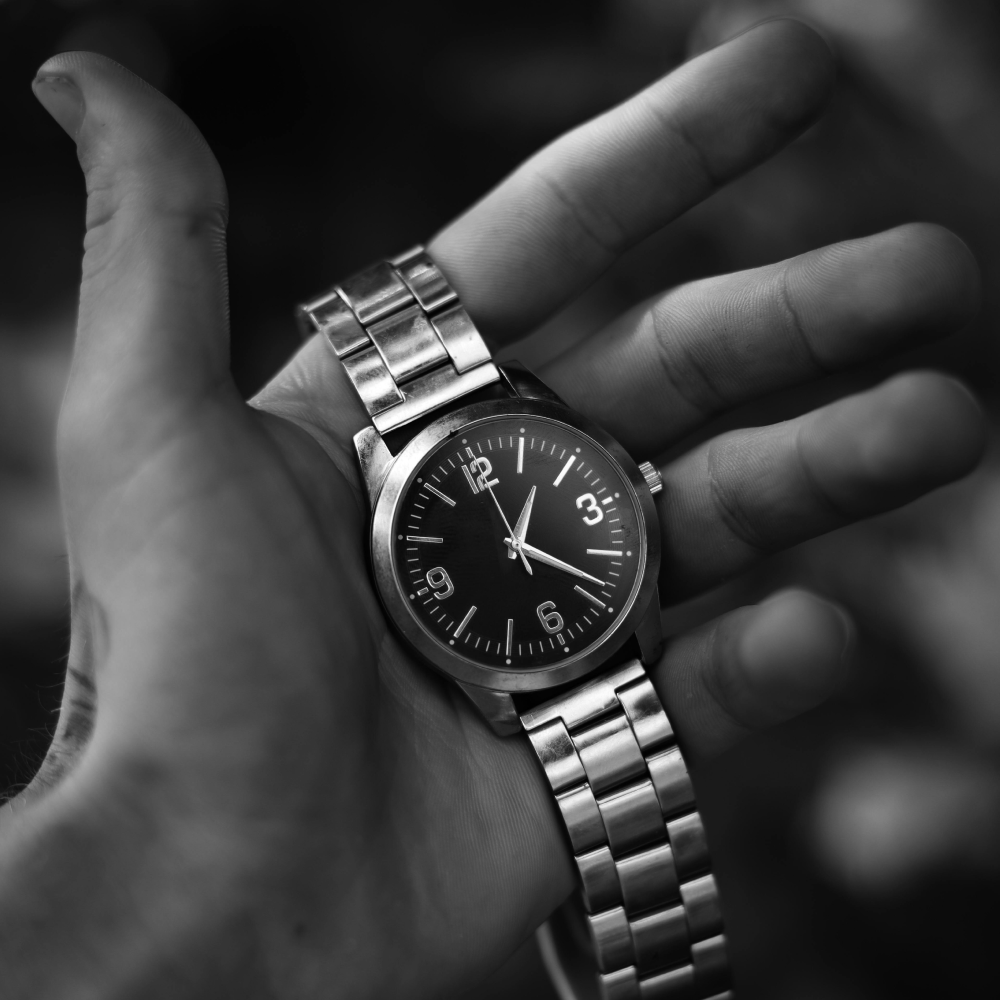 Silver wristwatch with black face.