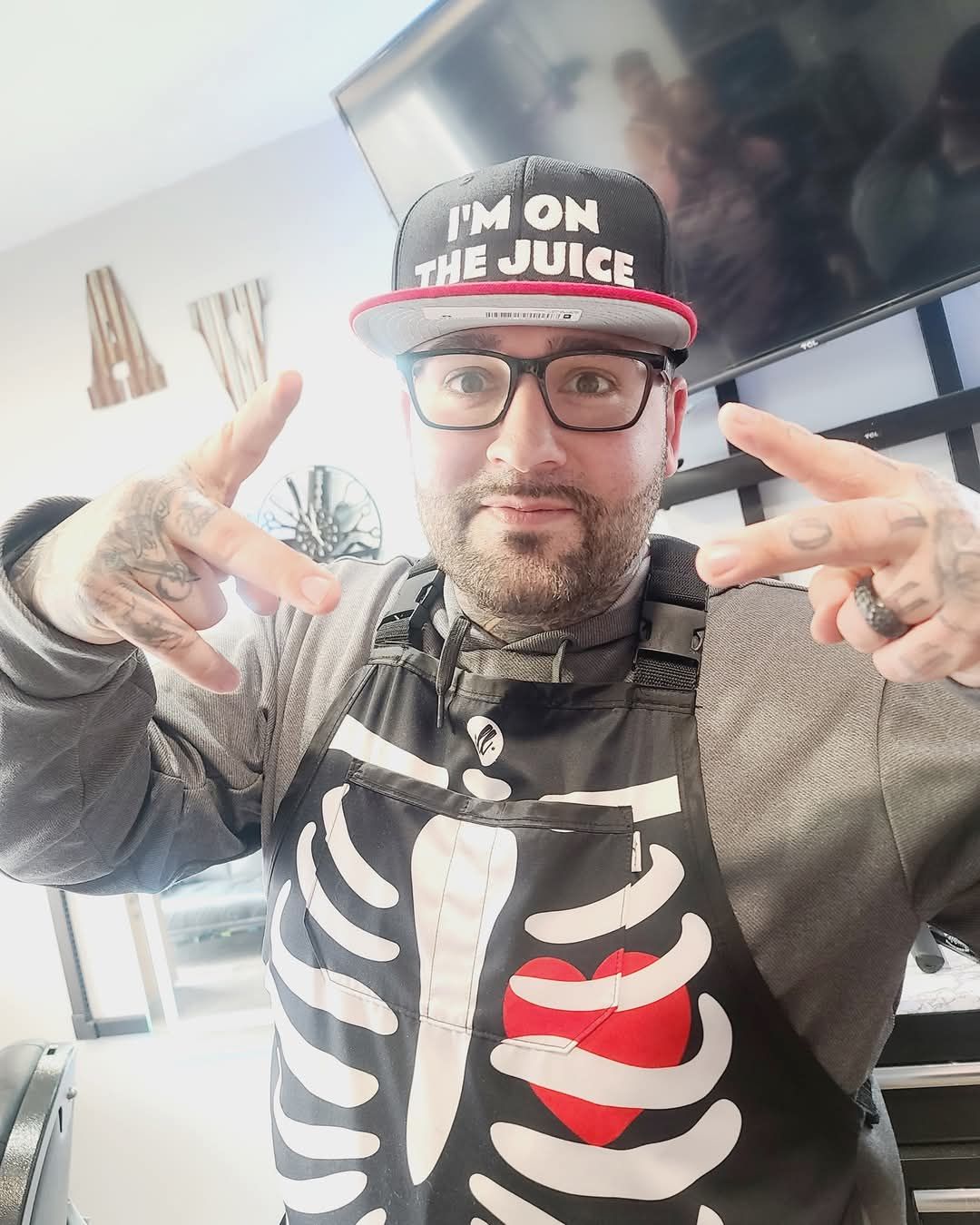 A man wearing a skeleton apron and a hat that says i 'm on the juice