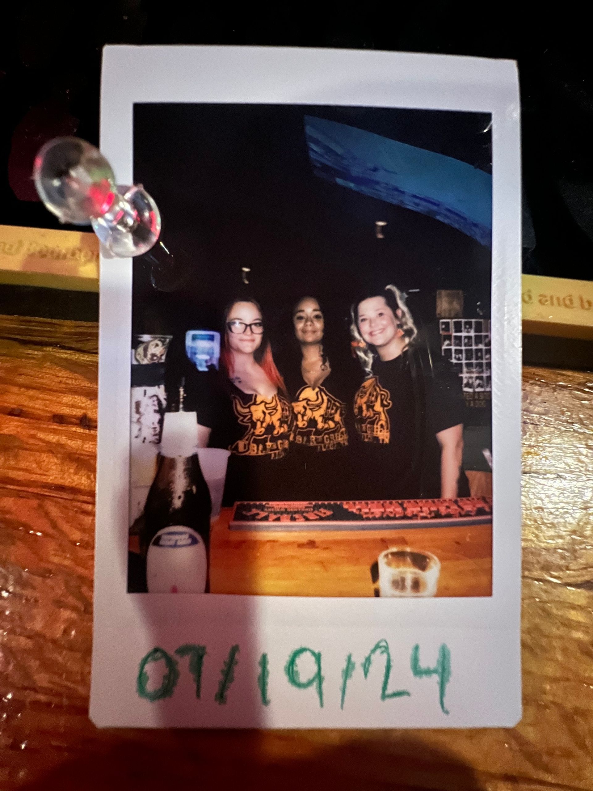 A polaroid picture of three women with the date 07/09/1924