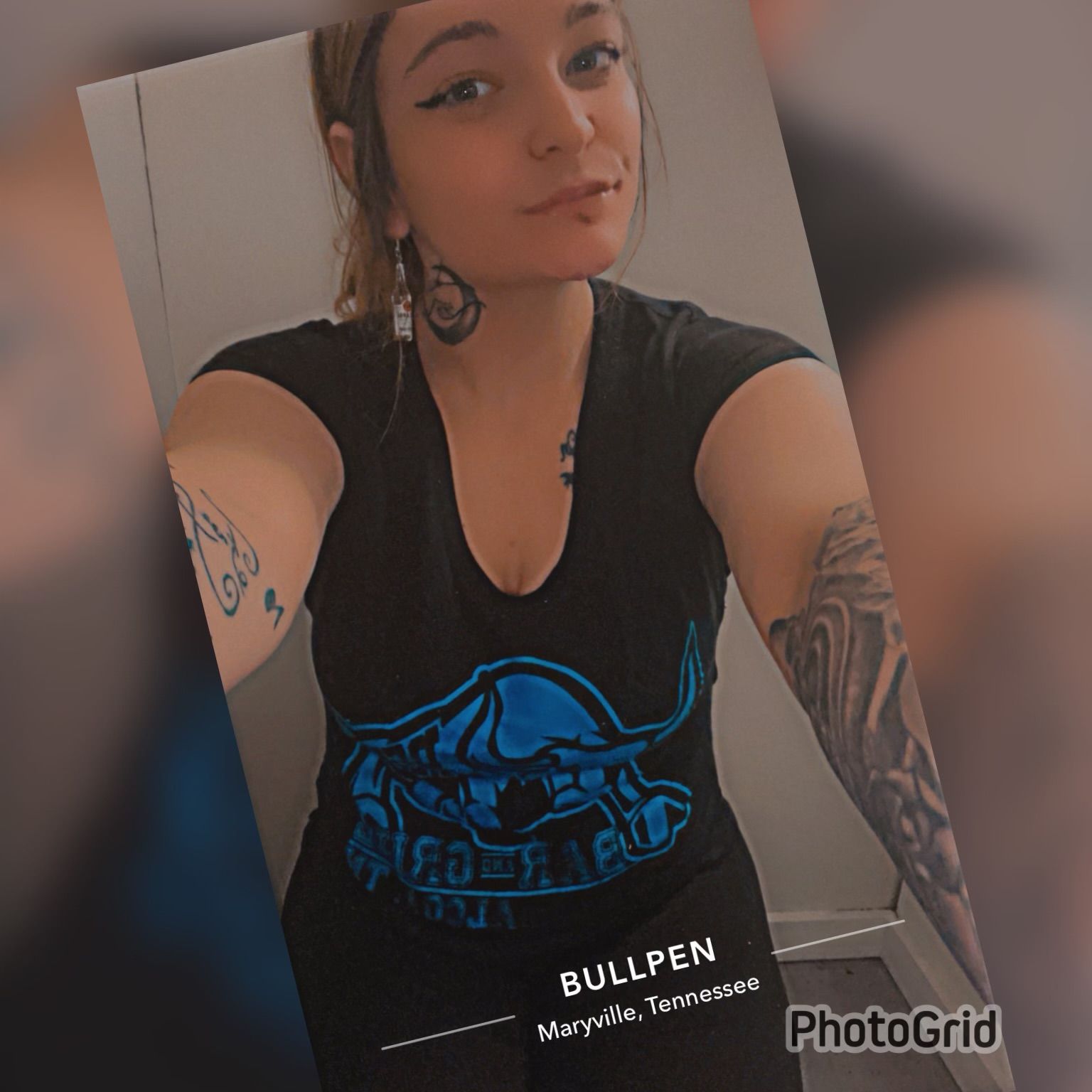A woman wearing a bullpen shirt takes a selfie