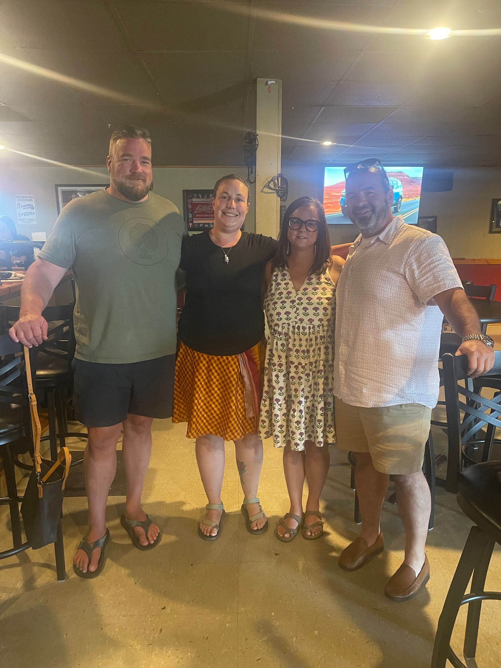 A group of people are posing for a picture in a restaurant.