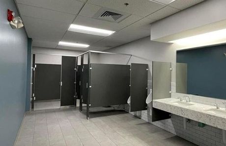 A public restroom with a sink and a mirror