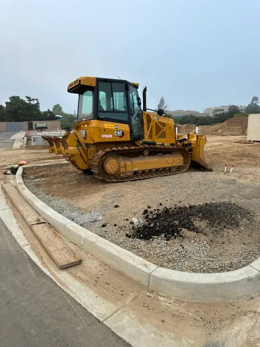 Yellow bulldozer on gravel, ready to work at a construction site.