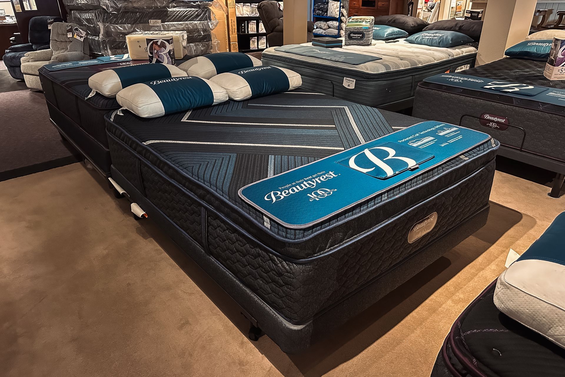 A mattress is sitting on top of a bed in a store.